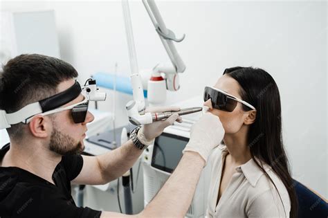 Premium Photo | Ent doctor in protective glasses holding surgical laser and doing laser ...