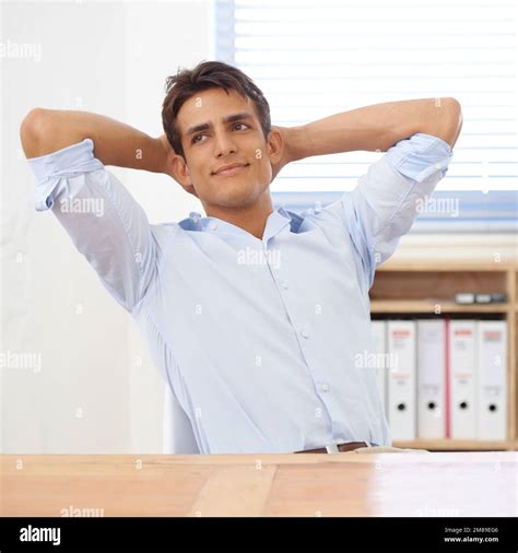 Dreaming up his next venture. a confident young businessman leaning ...