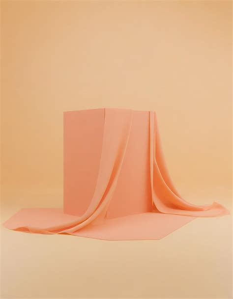 A piece of orange fabric with a white background with a design on the ...