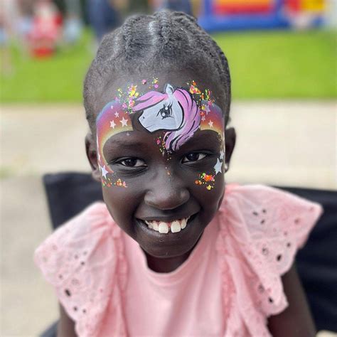 Unicorn Face Painting - painting of unicorn in fence
