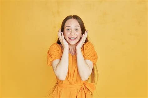 Smiling for the camera young woman in casual clothes standing indoors ...