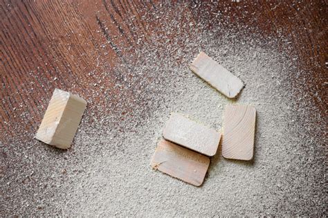 Premium Photo | Cut pieces of wood with sawdust on brown wooden floor