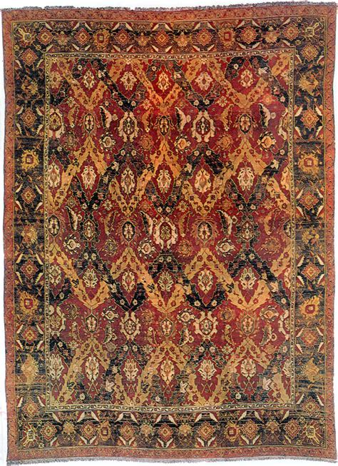 这种来源于高加索龙毯的印度地毯，深红的底色上缠绕在一起的团花图饰，非常漂亮-外国地毯织品纹样-图片