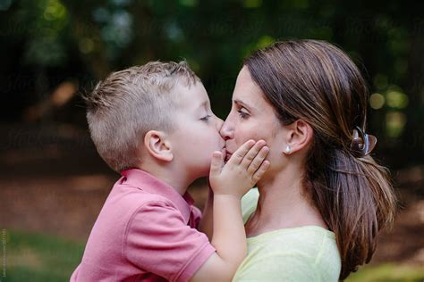 "Cute Young Boy Giving His Mother An Affectionate Kiss On The Mouth" by ...