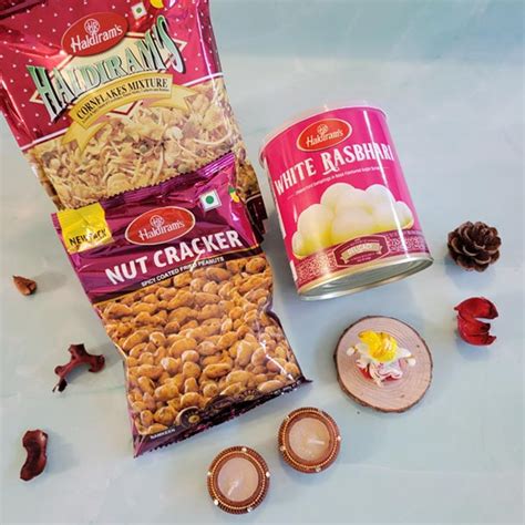 Send Haldiram cornflakes mix and nutcracker with Ganpati idol, kaju ...