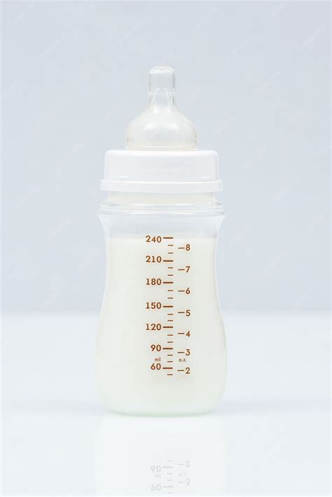 Baby milk bottle on a light background. full baby milk bottle | Premium ...