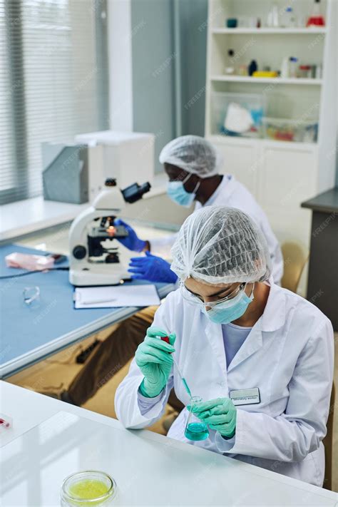 Premium Photo | Vertical shot of medical laboratory with two scientists working on research