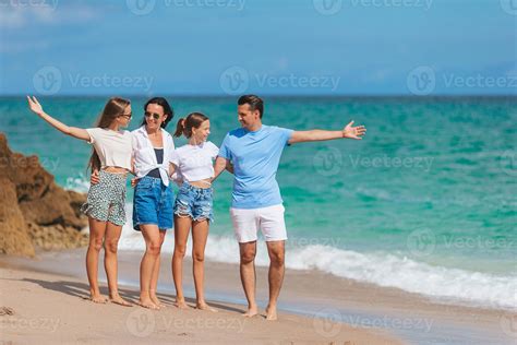 Family of four have fun together on beach vacation in Florida 18043796 ...