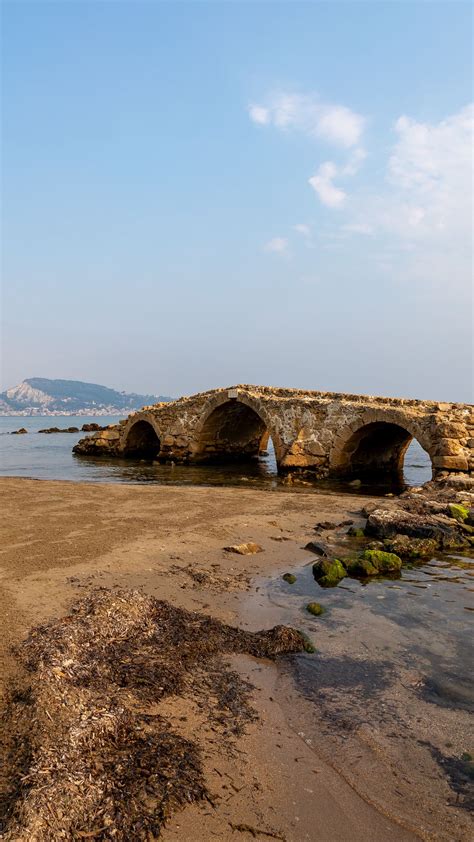 Download wallpaper 1350x2400 bridge, arches, ruins, shore, sea iphone 8 ...