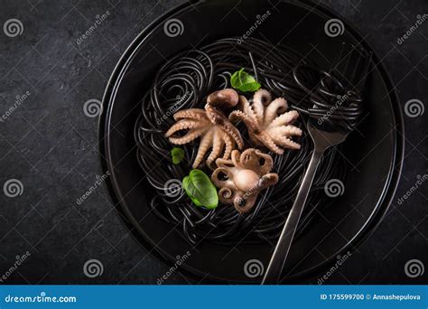 Squid Ink Spaghetti Pasta with Octopuses in Black Bowl Stock Photo ...