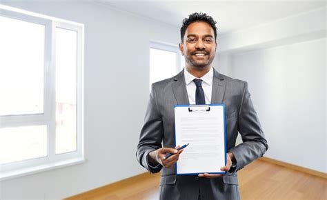 Indian man realtor with contract at new apartment | Premium Photo