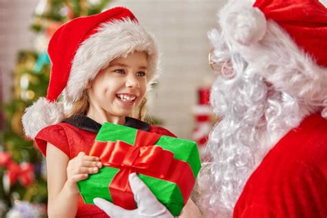 给可爱的小女孩送礼物的圣诞老人图片-圣诞老人给可爱的小女孩送礼物素材-高清图片-摄影照片-寻图免费打包下载