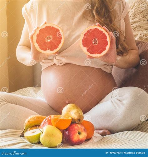 Pregnancy and Healthy Organic Nutrition. Pregnancy and Grapefruit. Pregnant Woman Enjoying Fresh ...