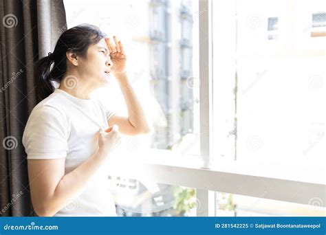 Asian Woman Looking Out Window at Strong Sunlight,hot Weather,high Temperature Heat Wave,harsh ...
