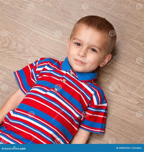 Child lie on the floor stock photo. Image of floor, innocent - 20562334