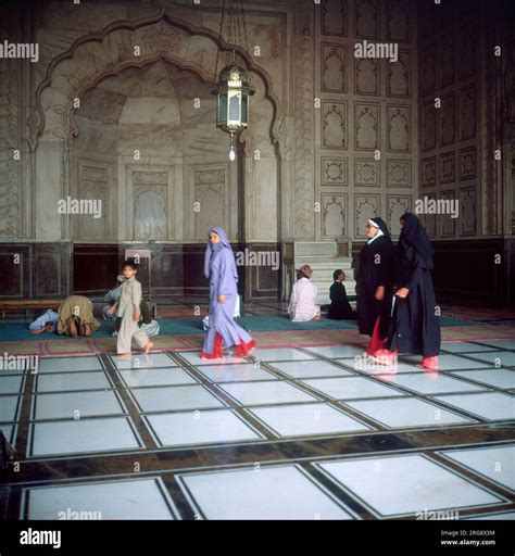 Worshippers inside the BADSHAHI MOSQUE, one of the largest mosques in the world, built by ...