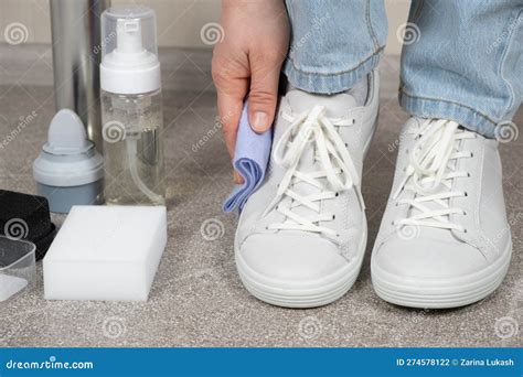 Cleaning White Shoes, Caring for Sneakers. a Woman Wipes Her Leather ...