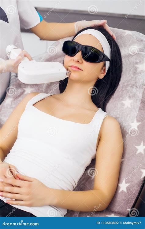 Face Care. Facial Laser Hair Removal. Beautician Giving Laser Epilation Treatment To Young Woman ...