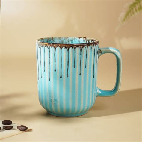 Subtle Sophistication: Light Blue Ceramic Coffee Mug with Brown Accents ...