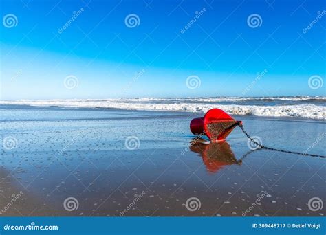 Red Buoy on Wet Sands with Foamy Sea Waves in Spain Stock Image - Image ...