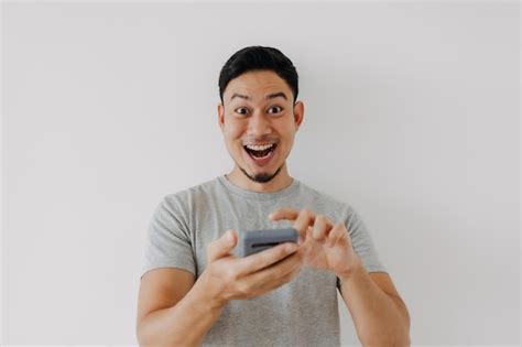 Wow and surprise face man use smartphone with copy space of ...