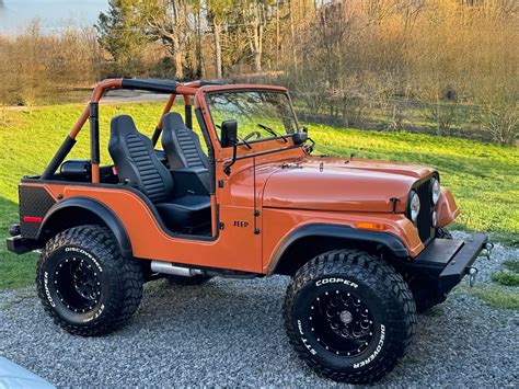 Orange Jeep Rubicon on Gravel