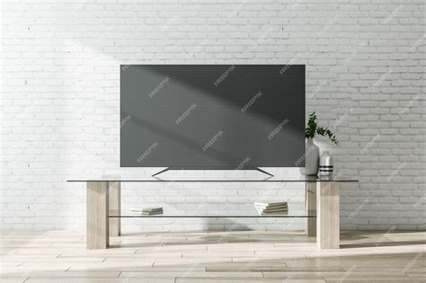 Premium Photo | Black tv screen with furniture on brick wall background ...