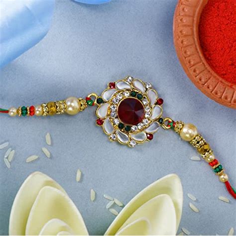 Buy Riddhika Ventures Gold Plated Kundan and Pearl Rakhi with Roli ...