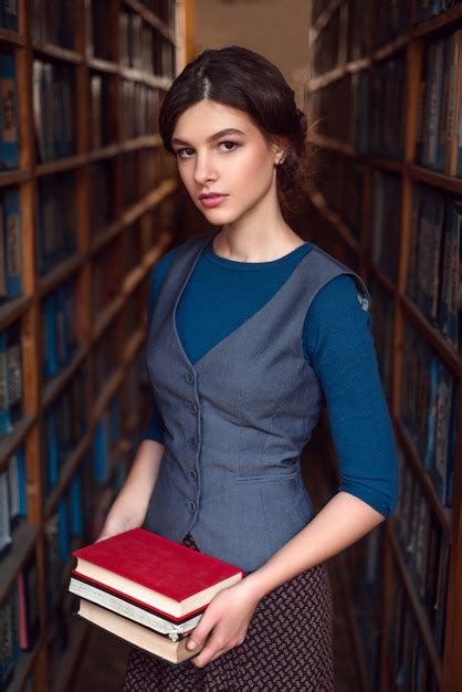 Young girl choose books for reading. | Premium Photo