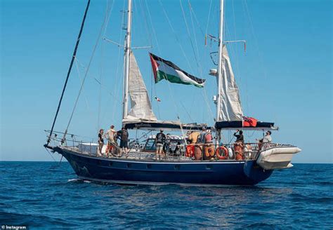 Greta Thunberg covers head during departure from Israel