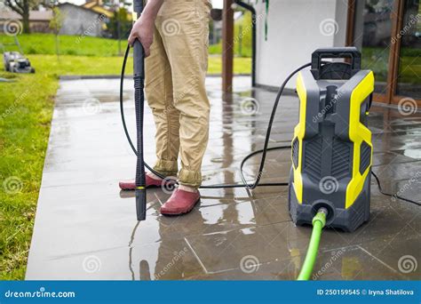 Pressure Washer Cleaning Machine on Wet Concrete Floor Near the House ...
