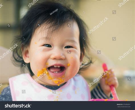 Baby Girl Eating Mashed Sweet Potatoes Stock Photo (Edit Now) 579390391 - Shutterstock