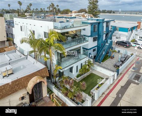 Aerial view of blue and white modern multi story beach homes on Mission ...