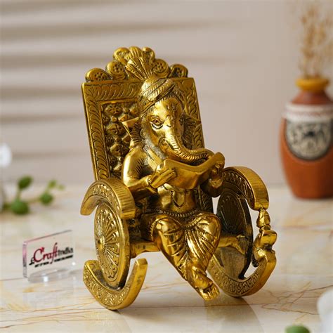Golden Metal Handcrafted Lord Ganesha Idol Reading Book on Rocking Cha ...