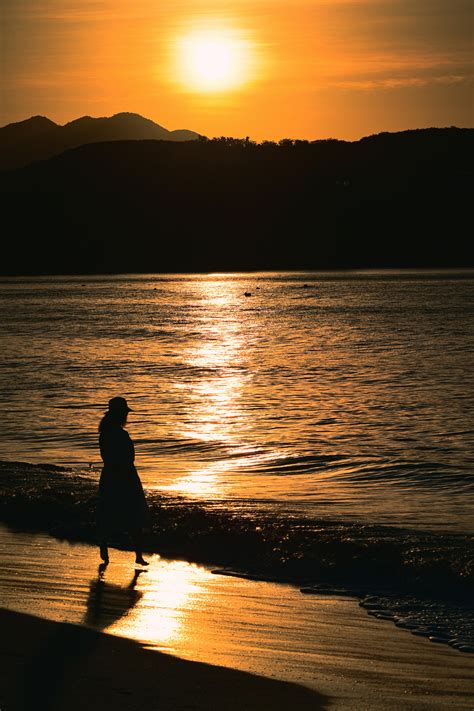 Woman Walking Alone On Beach Free Stock Photo Of Woman Walking On The