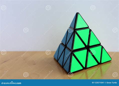 Rubik`s Pyraminx Cube On A Table Editorial Image | CartoonDealer.com ...