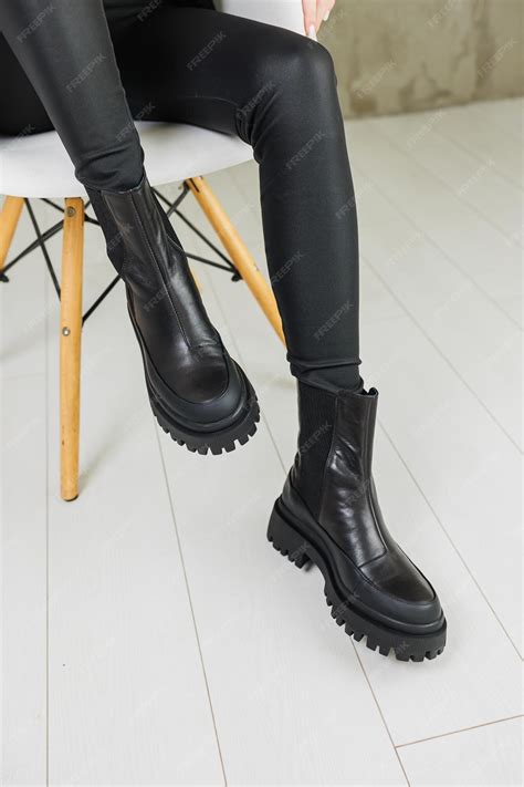 Premium Photo | Slender female legs in black leather boots made of ...