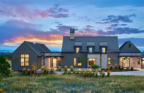 Contemporary farmhouse with dark siding and stone exterior | Modern ...