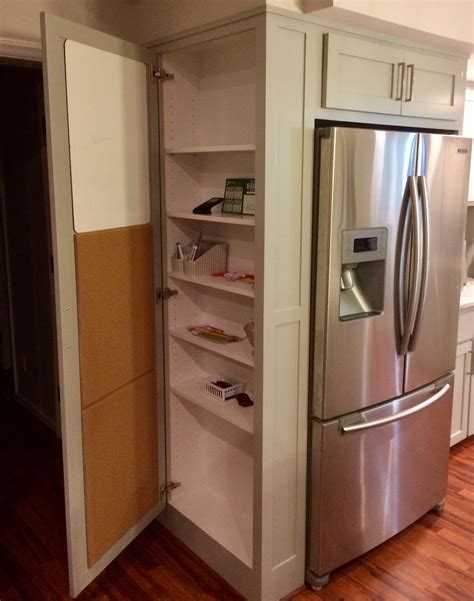 a stainless steel refrigerator and freezer combo in a kitchen with hardwood floors, white ...