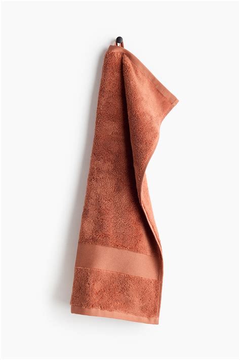 Rust red Soft terry hand towel at H&M Home | H&M IN
