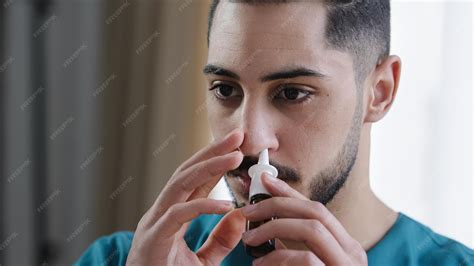 Premium Photo | Portrait of sick caucasian man doctor in nurse medical uniform treating runny ...