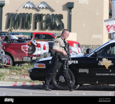 Authorities investigate a shooting in the parking lot of the Twin Peaks ...