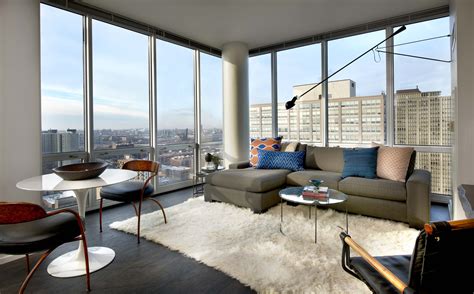 Floor to ceiling windows, Grey sectional sofa, Apartment decor