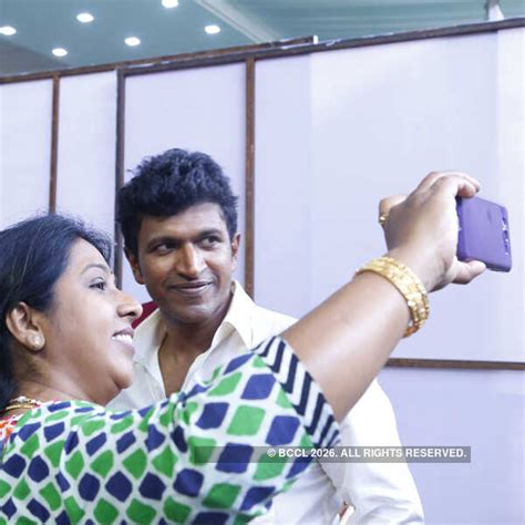 A guest takes a selfie with Puneeth Rajkumar during the wedding ceremony