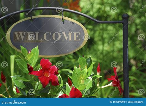 Metal Garden Welcome Sign with Red Flowers Stock Photo - Image of ...