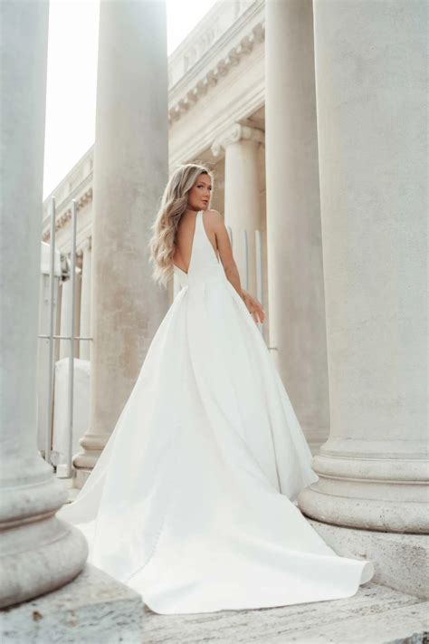 7755 | Stella York | Modern Luxe Ballgown Wedding Dress with Deep V-Neckline | Essense Designs