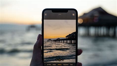 Download wallpaper 1920x1080 phone, hand, sunset, shooting full hd ...