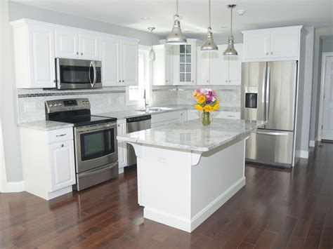 Gorgeous modern kitchen with white cabinets, stainless steel appliances ...