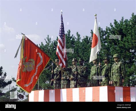 Both the Marine and Japanese Color Guard stand tall, rendering proper ...