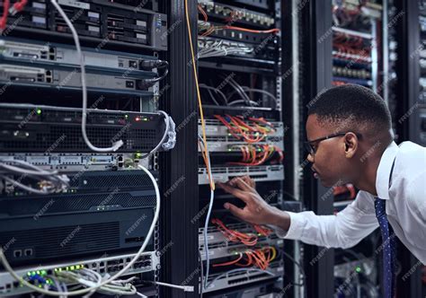 Black man it technician and server room for cyber security data or ...
